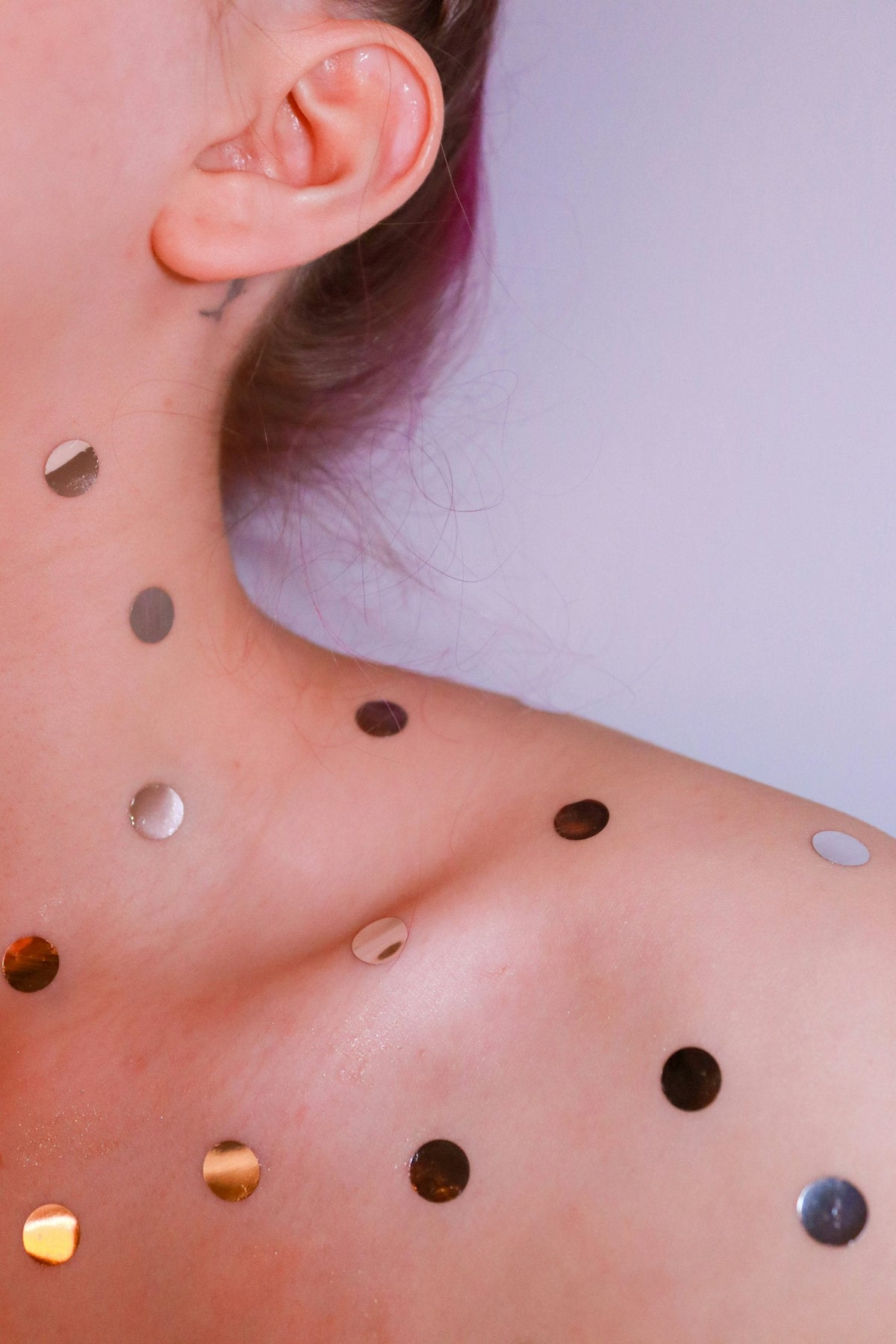 Types of earrings: woman wearing silver stud earrings